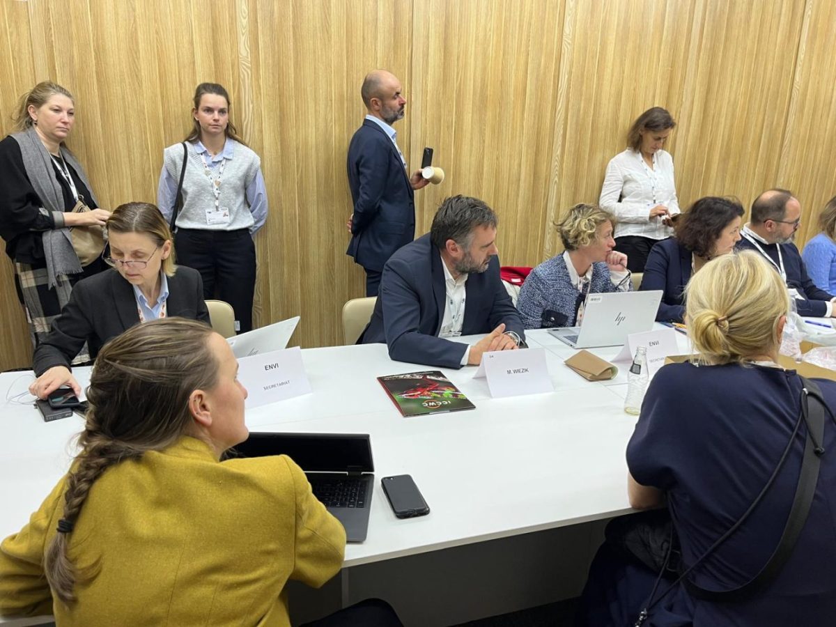 A group of people surrounded around a table.