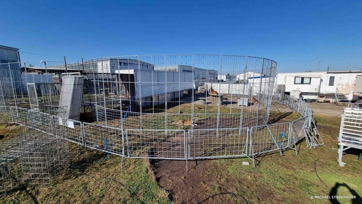 Enclosure at former owner, consisting of circus trailer and fencing.