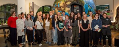 Group of people standing in front of a large globe
